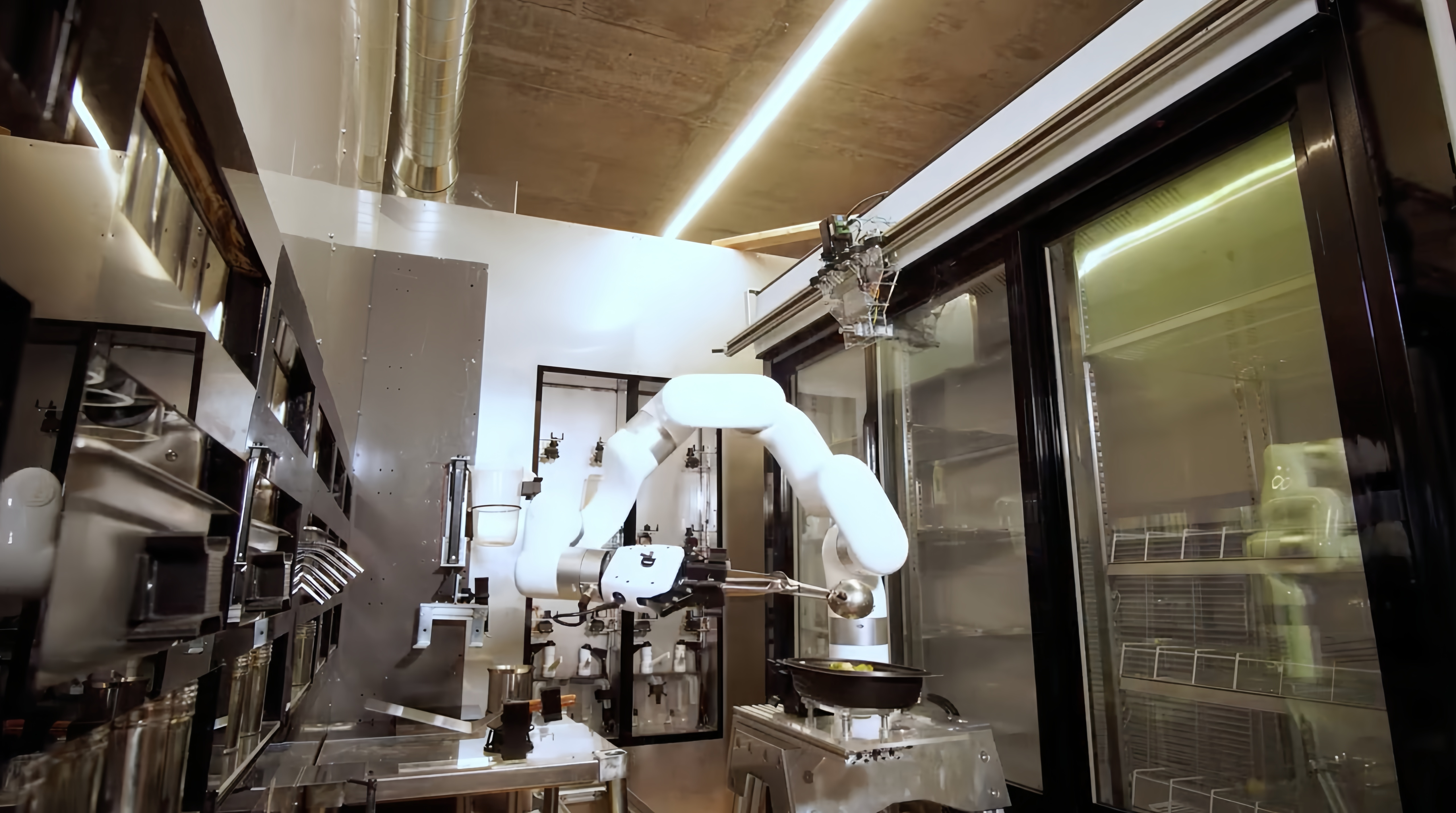 UFACTORY cobot holding a ladle over a pan on a cooktop in an automated kitchen station