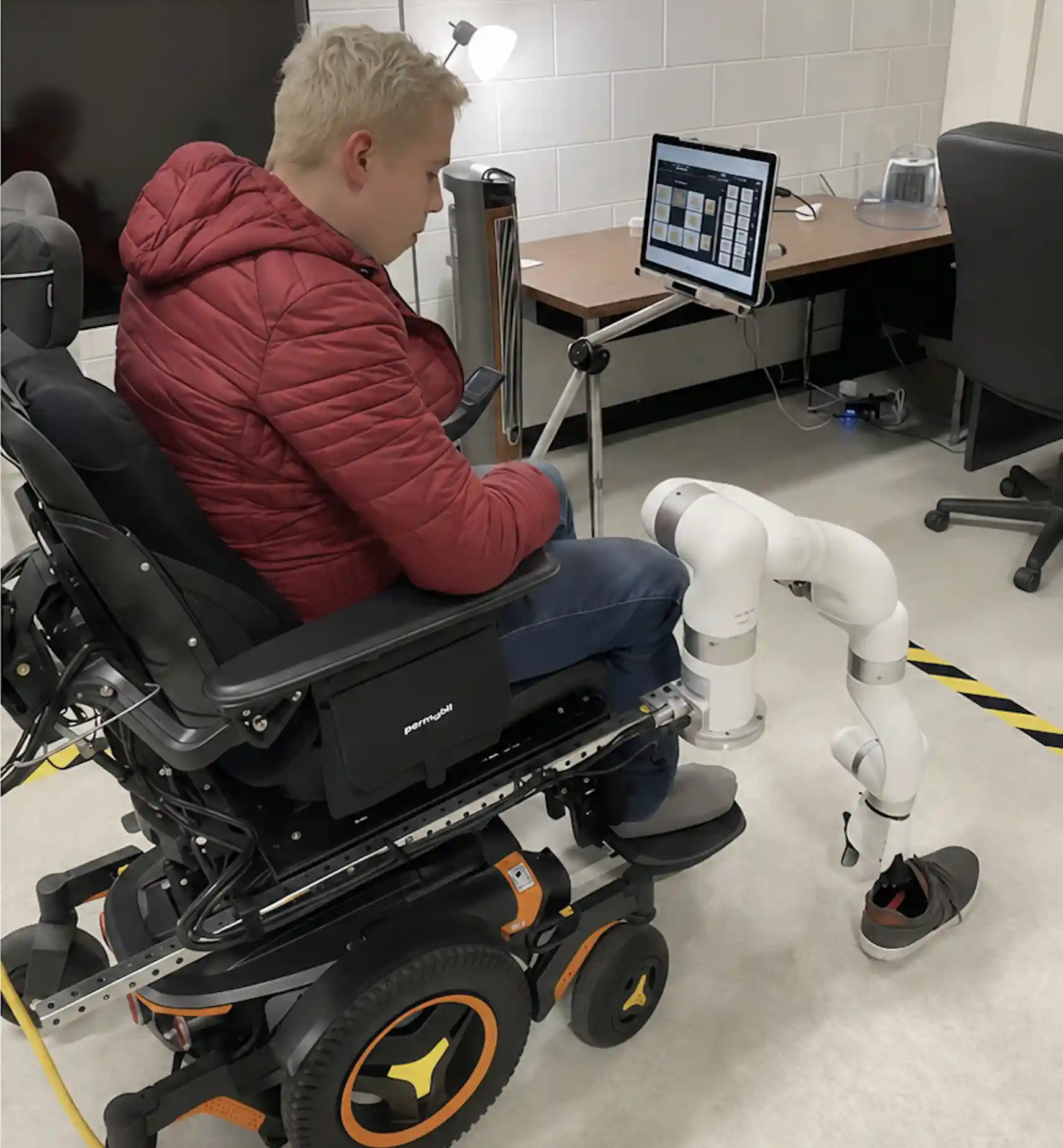 Wheelchair-mounted xArm 6 reaches toward a shoe during an assistive manipulation test at UWM BioRobotics Lab